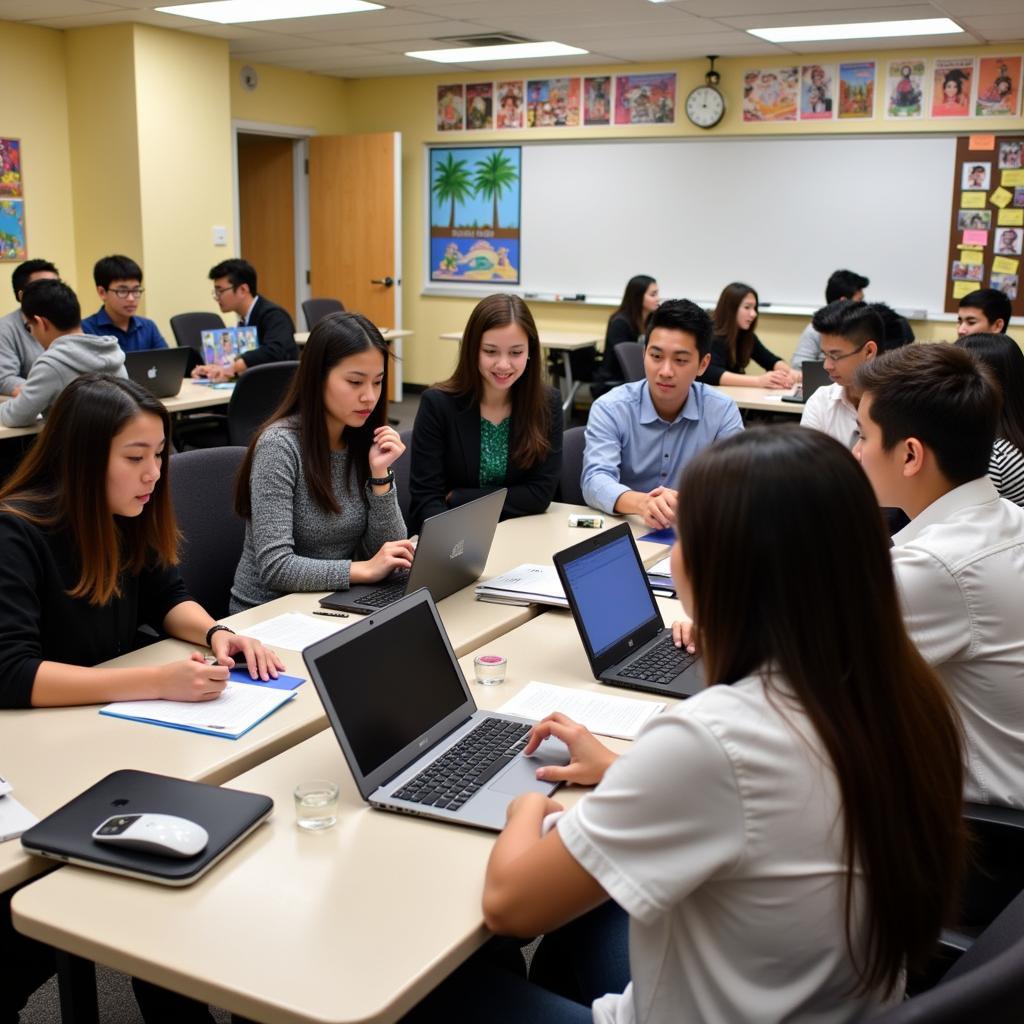 Students collaborating on a group project about Southeast Asian culture, using laptops and textbooks.