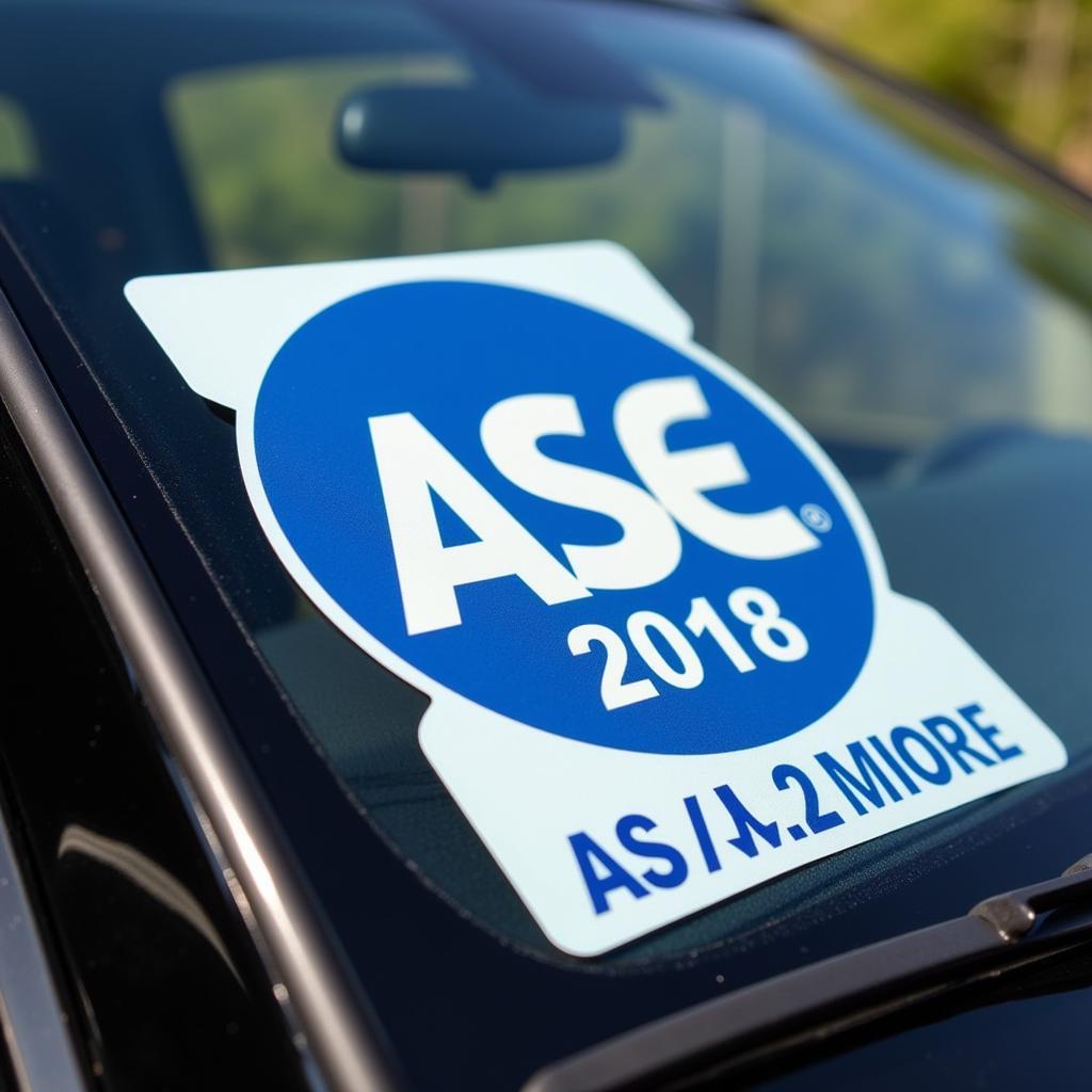 Close-up view of an ASE oil change sticker showing the date and mileage for the next oil change.